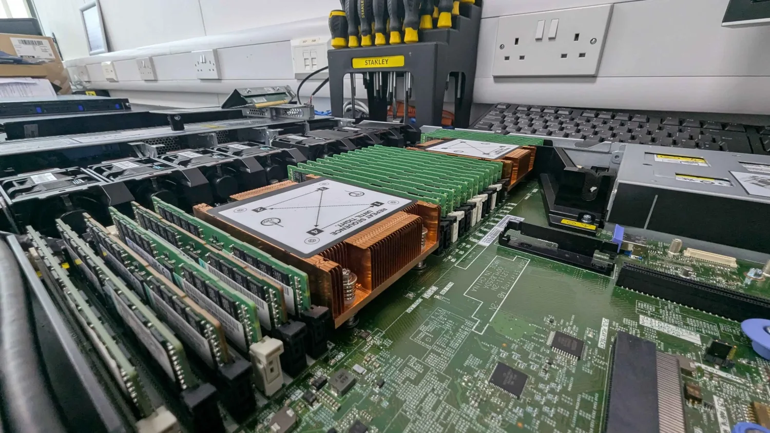 A Xeon server open on the bench, showing copper heatsinks and banks of ECC memory